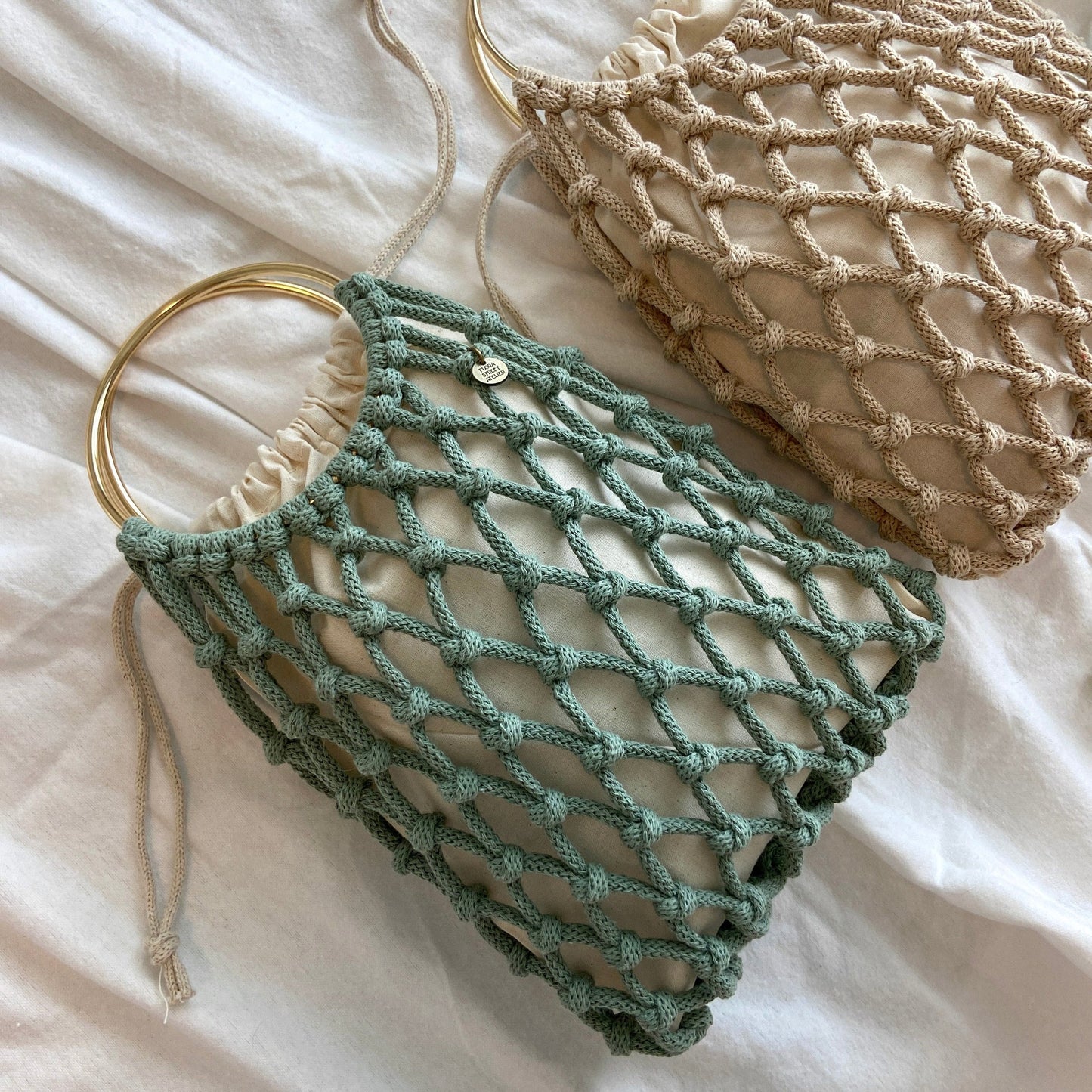 2 Sustainable handwoven macrame net bag with recycled cotton cord one in sage colour, one in beige colour, perfect for market or beach days
