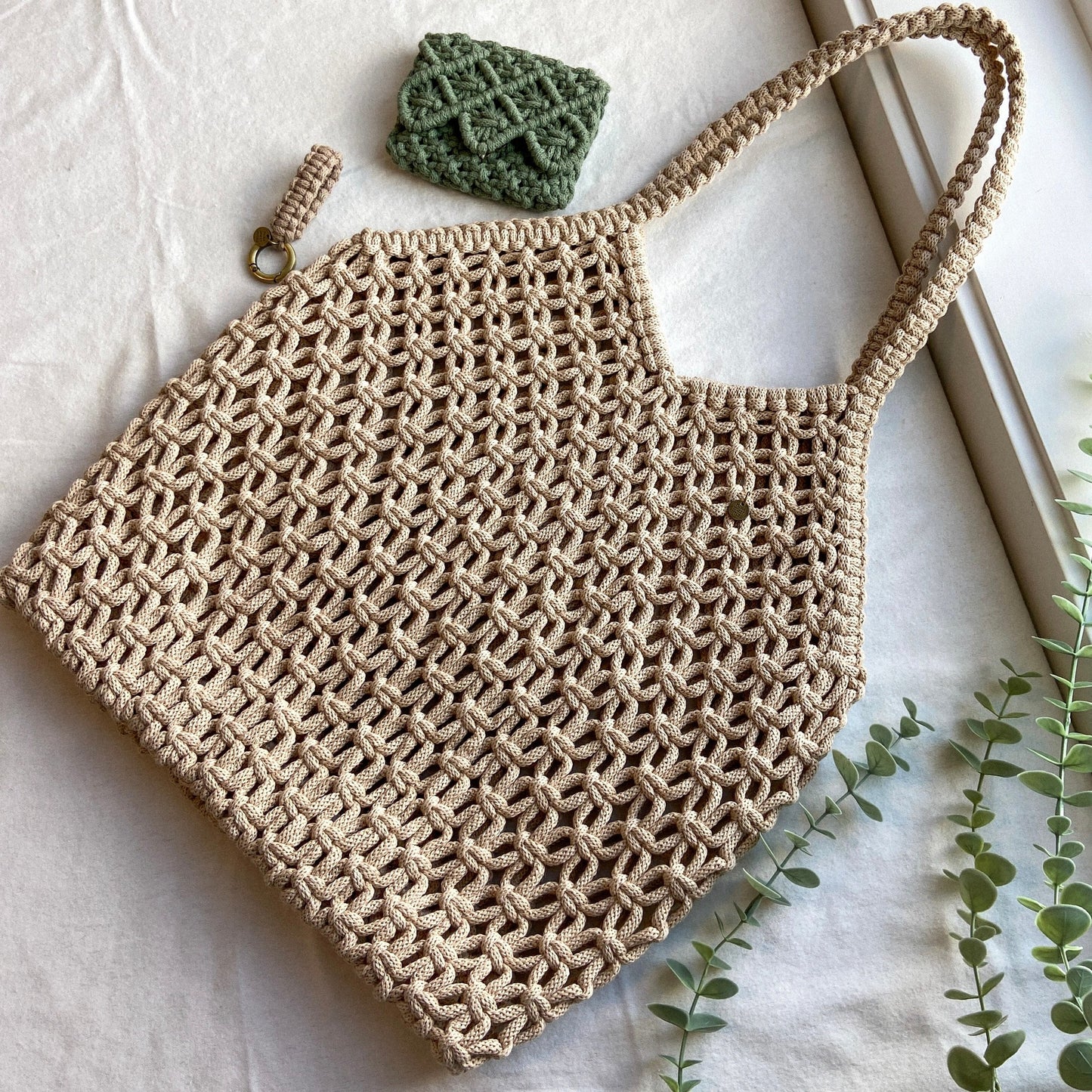 Hand knotted macrame beach bag with soft open weave and wide shoulder straps, handmade by Flora Street Atelier, crafted in Canada with recycled cotton
