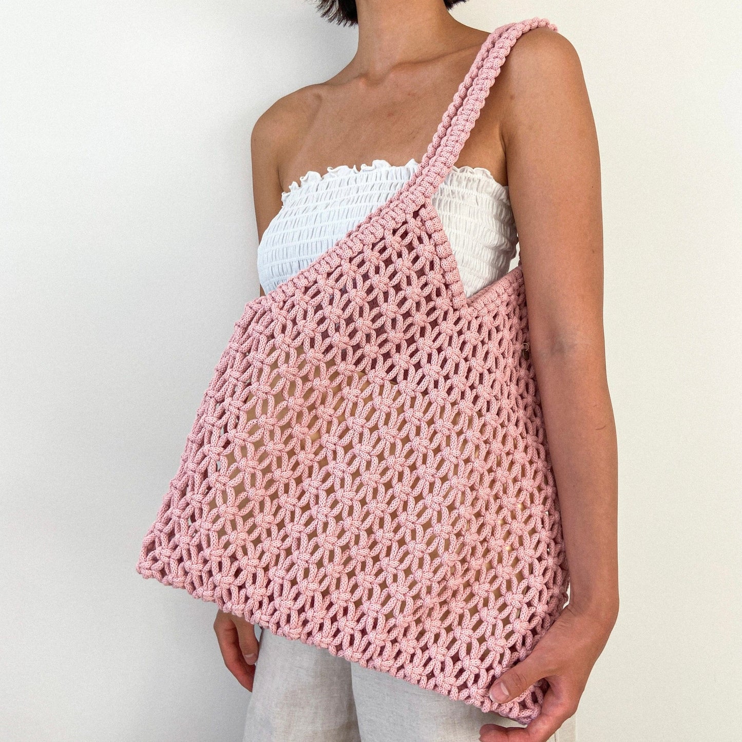 Hand knotted macrame beach bag with soft open weave and wide shoulder straps, handmade by Flora Street Atelier, crafted in Canada with recycled cotton
